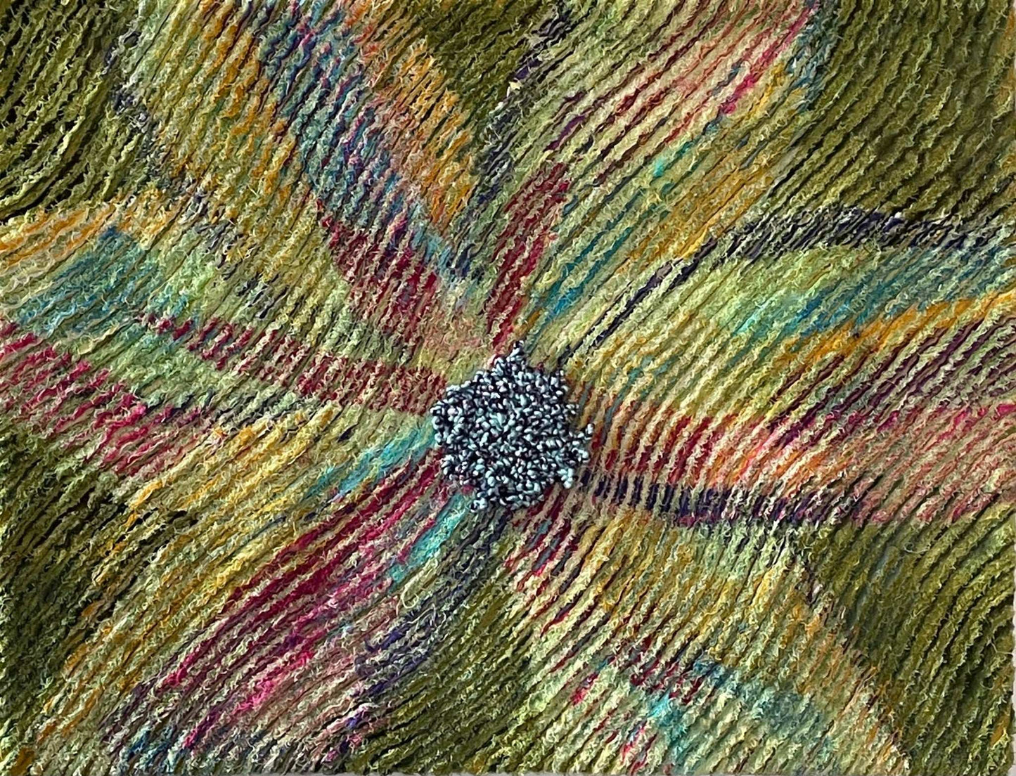 Blossoming: Abstract Floral Textile Art by Miki Howell features multicolored petal designs radiating from a blue-gray center on a green-yellow wavy background—a perfect handcrafted home decor piece.