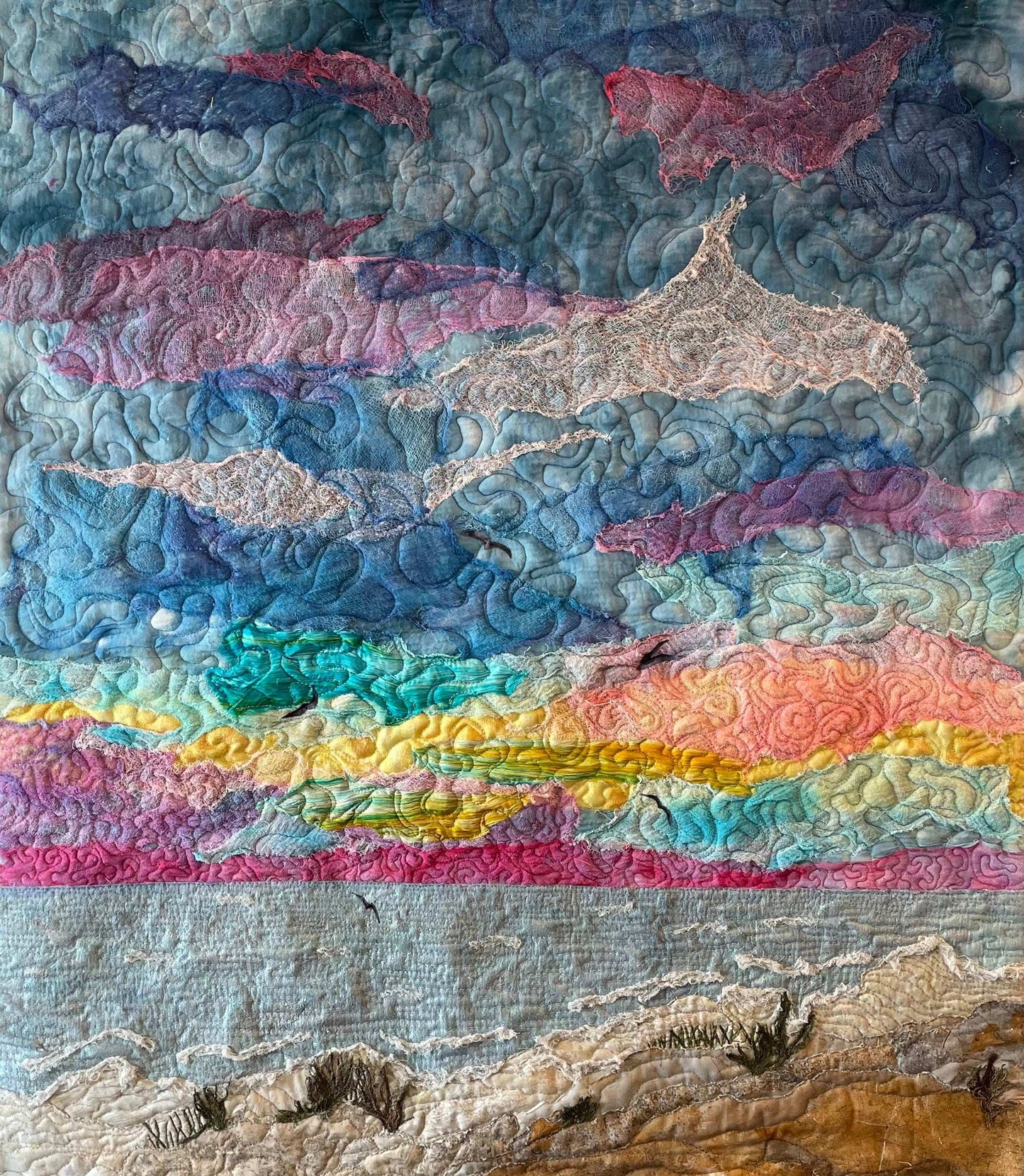 Wallhanging depicting a sunset over the ocean and beach