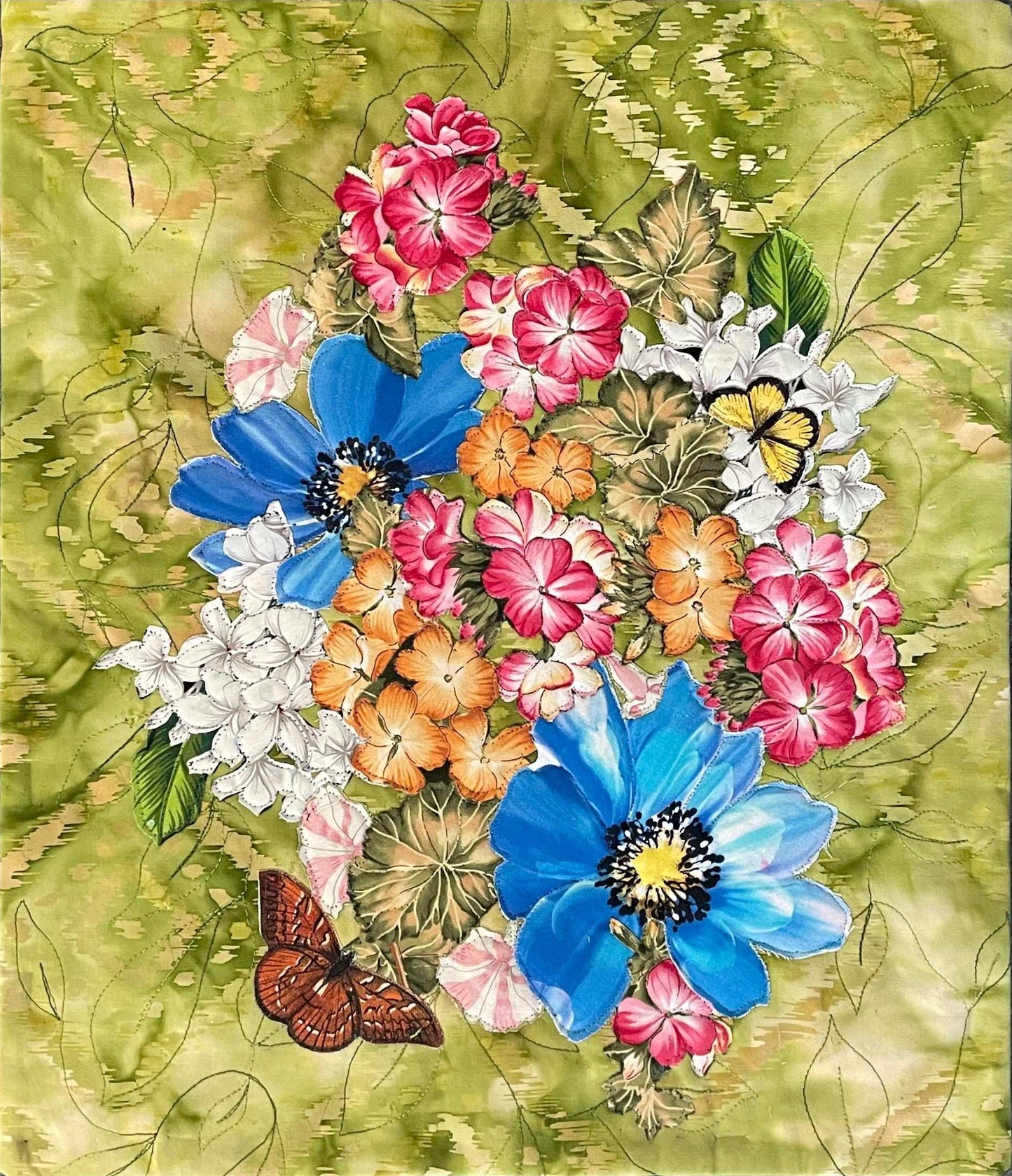 The “Drenched in Sun: A Floral Textile Art Wallhanging” by Miki Howell features a vibrant bouquet in blue, pink, white, and orange with green leaves on textured green fabric and a brown butterfly resting near the base.