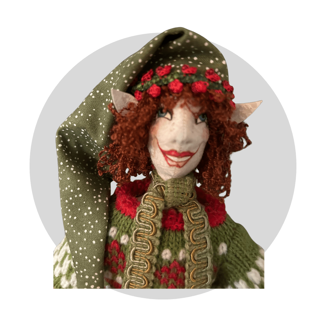 Pierrenoel: Art Doll by Mary Cantore features curly red hair, pointy elf ears, a green and white polka-dot hat, and a knitted green sweater with red and white accents—a charming Christmas Elf for your collection.
