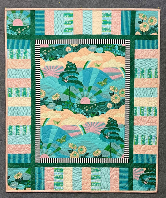 Escape: Quilted Wall Art by Mary Cantore features a central panel with trees, butterflies, flowers, and rainbows in green, pink, and blue. The border adds intricate striped, geometric, and floral patterns for a vibrant finish.