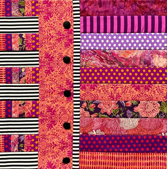 Bring vibrant style to your space with Mary Cantore’s Button-Down Bold: Quilted Wall Art—featuring colorful horizontal strips in pink, purple, orange, and yellow patterns plus a vertical striped panel with black buttons on the left.
