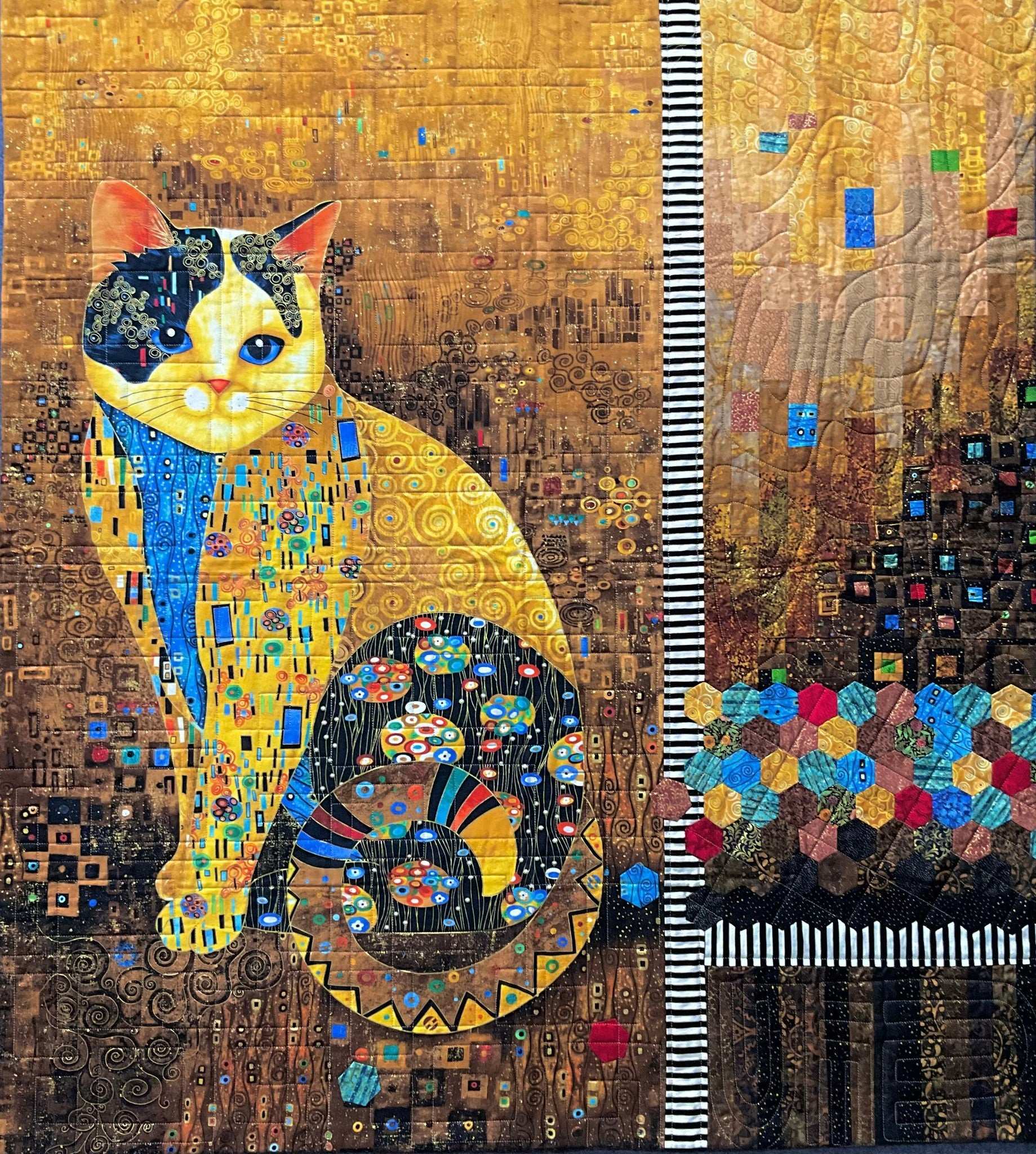 Cleo: Quilted Wall Art by Mary Cantore features a sitting cat with a detailed, patterned body and tail against a glowing golden mosaic background, striped column, and custom patchwork quilting inspired by Gustav Klimt.