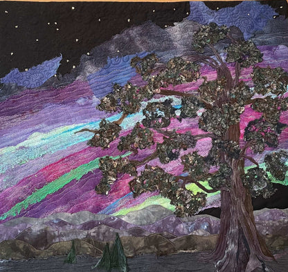 The Aurora Borealis: Landscape Art Quilt by Miki Howell features a handcrafted textured tree under a starry sky illuminated with vibrant pink, purple, and green tones above distant mountains—a stunning textile wall hanging.